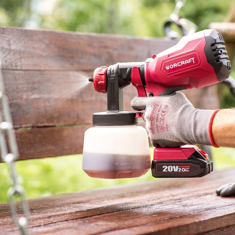 Аккумуляторный краскопульт WORCRAFT CSG-S20LiA наносит краску на деревянную скамью.